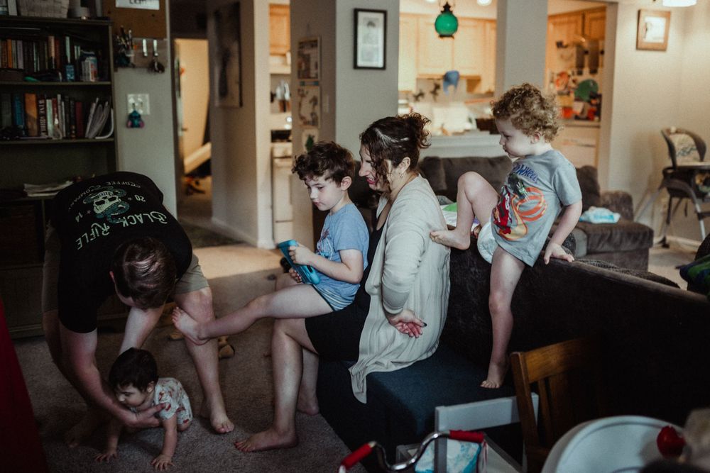 mom and dad getting their children ready for the day in their home