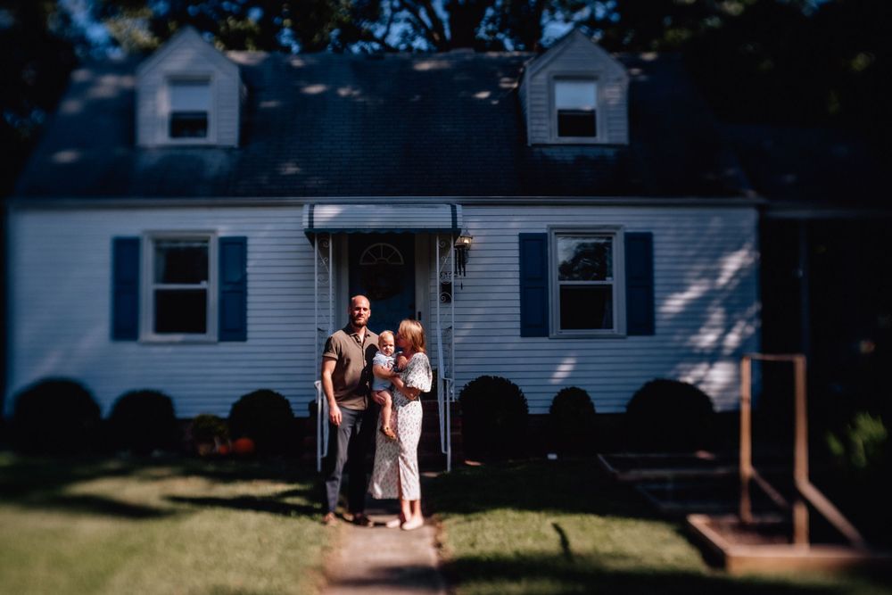family standing in front of their home with dappled sunlight in portsmouth, virginia