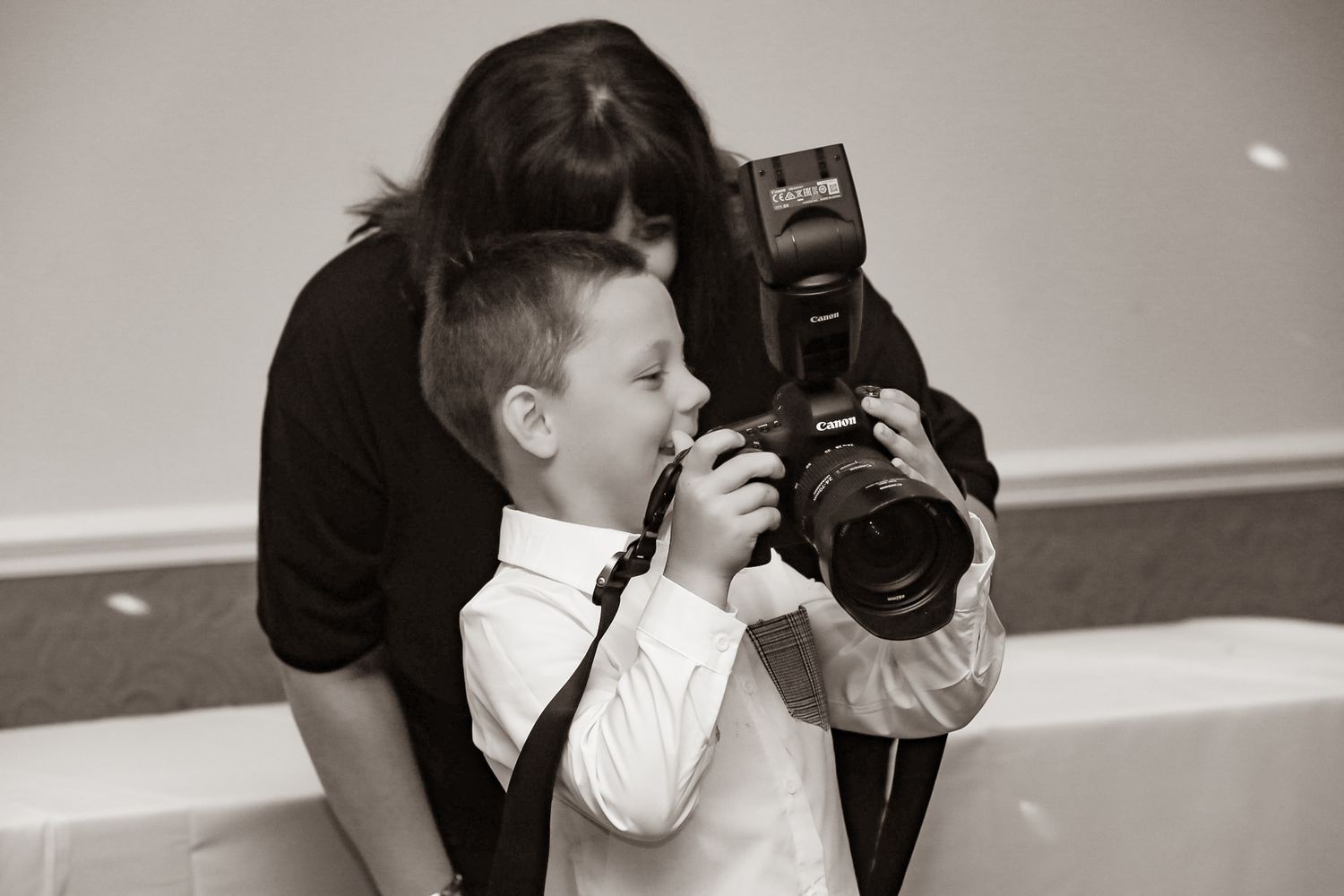 Black and white sequence of young boy interacting with photographer at an event.