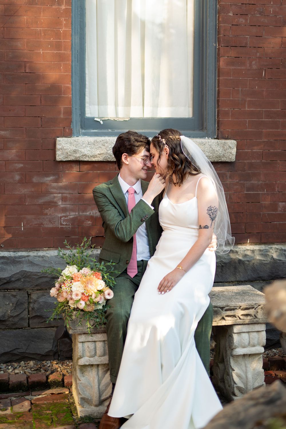 Romantic wedding photo session against rustic brick wall background.
