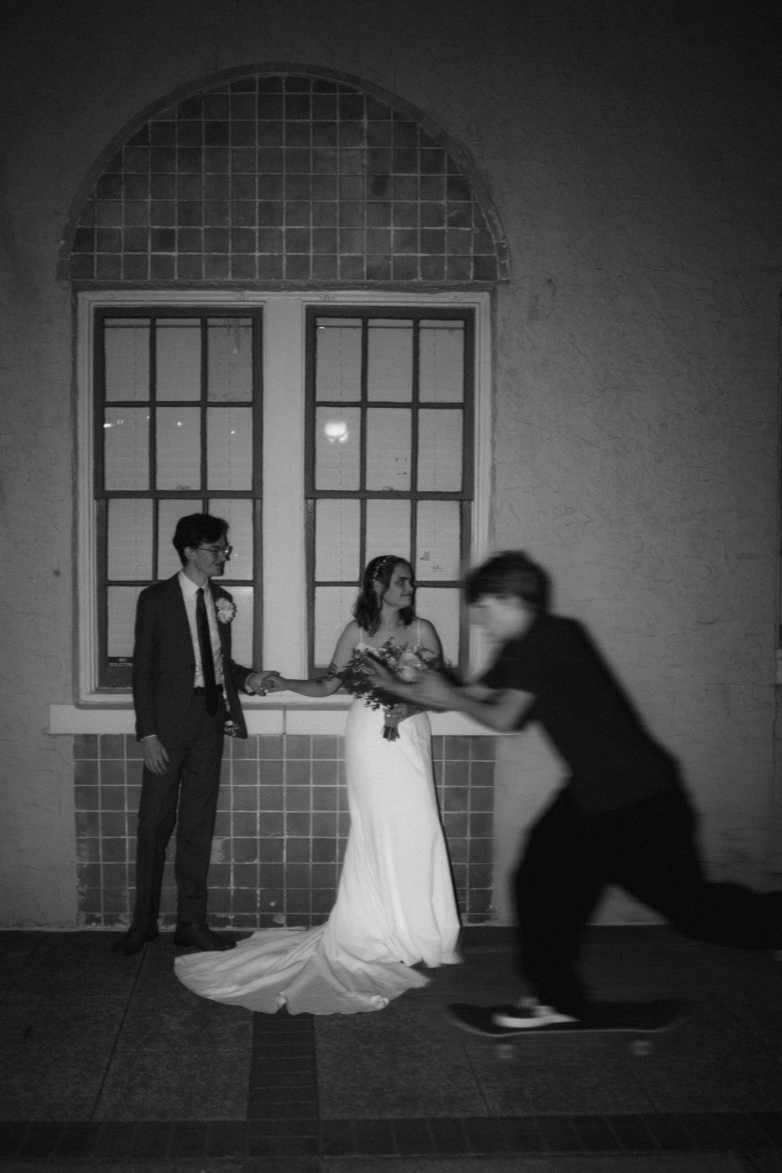 Artistic black and white silhouettes against a wall with arched windows.