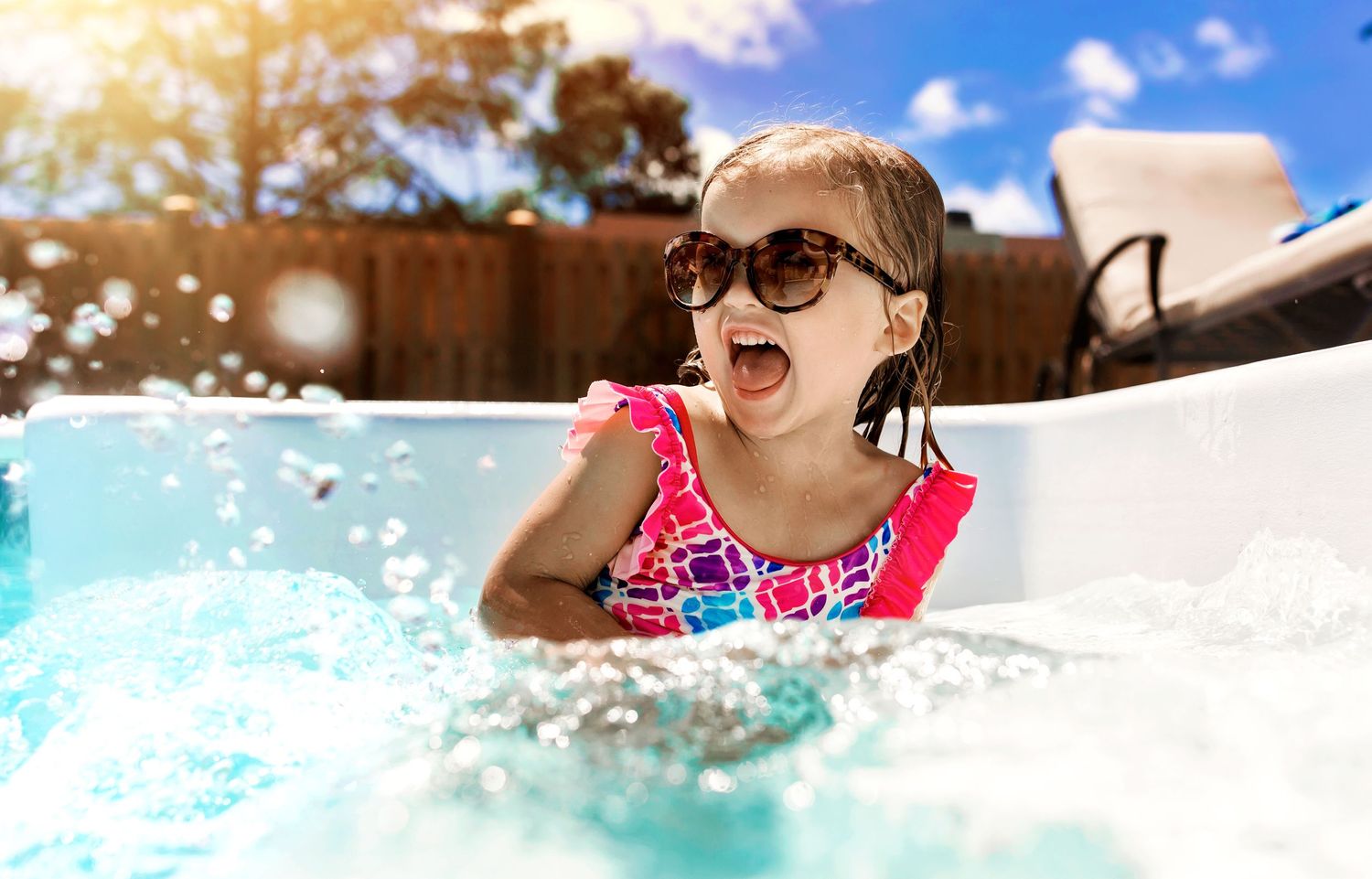 Summer fun captured with splashing water and sunlight in pool.