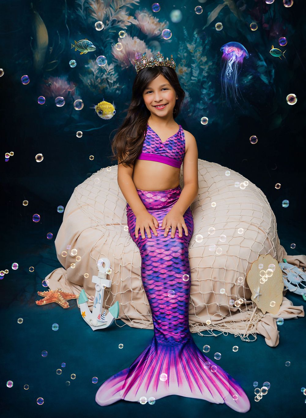 Enchanting mermaid photoshoot with purple tail and bubbles.