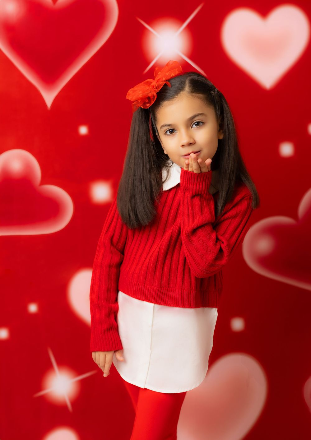 Valentine themed photo with red and pink hearts on bright red background.