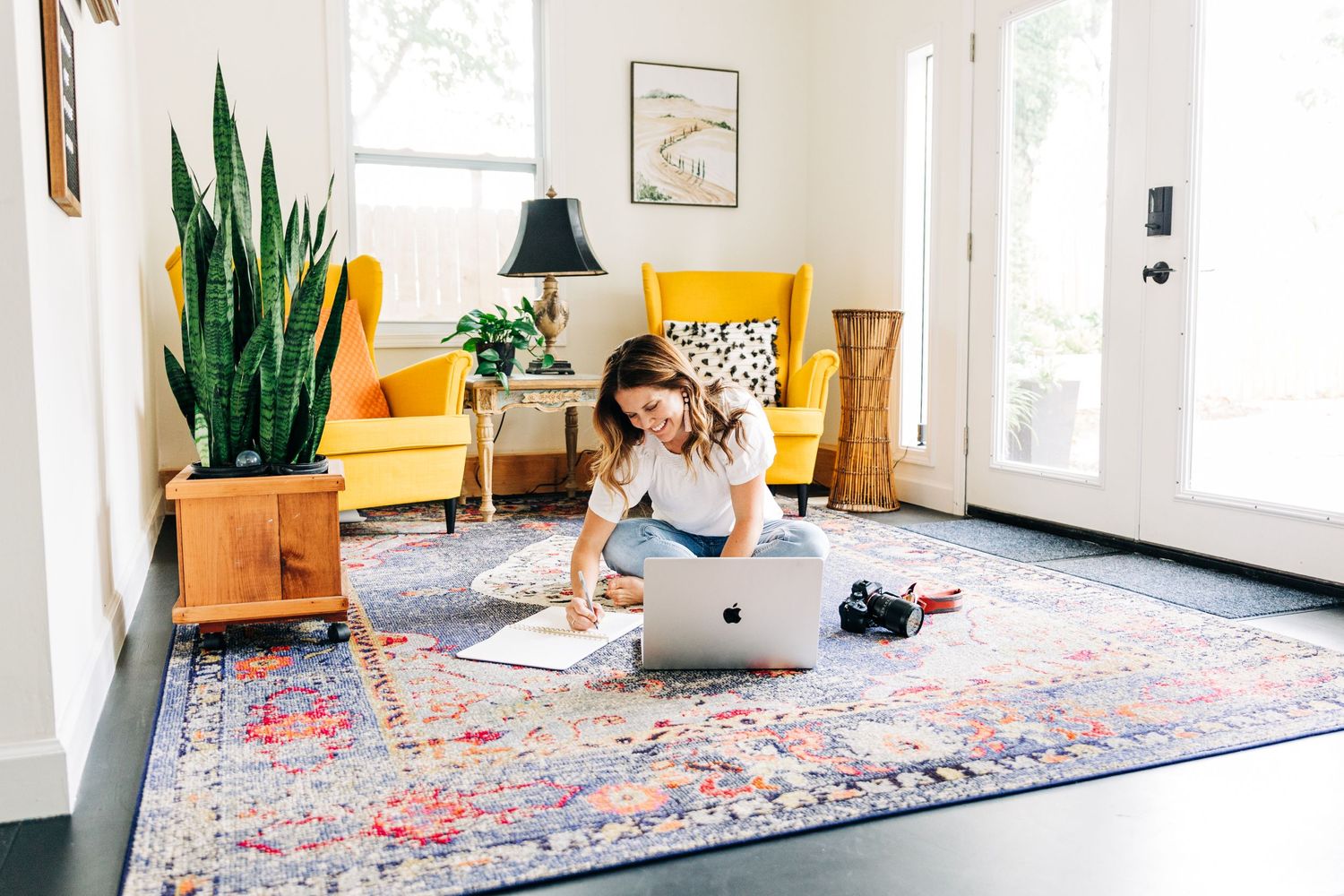 woman sitting on floor and working at her laptop for branding photos