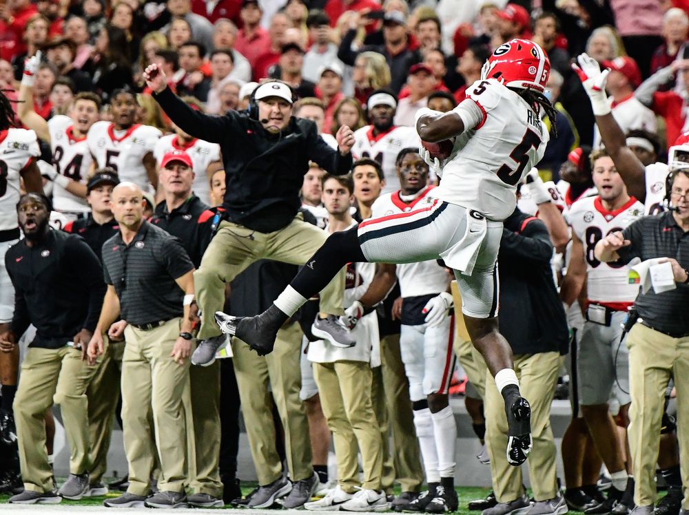 Ringo intercepts the ball in front of Kirby Smart to seal Georgia's National Championship against Alabama.