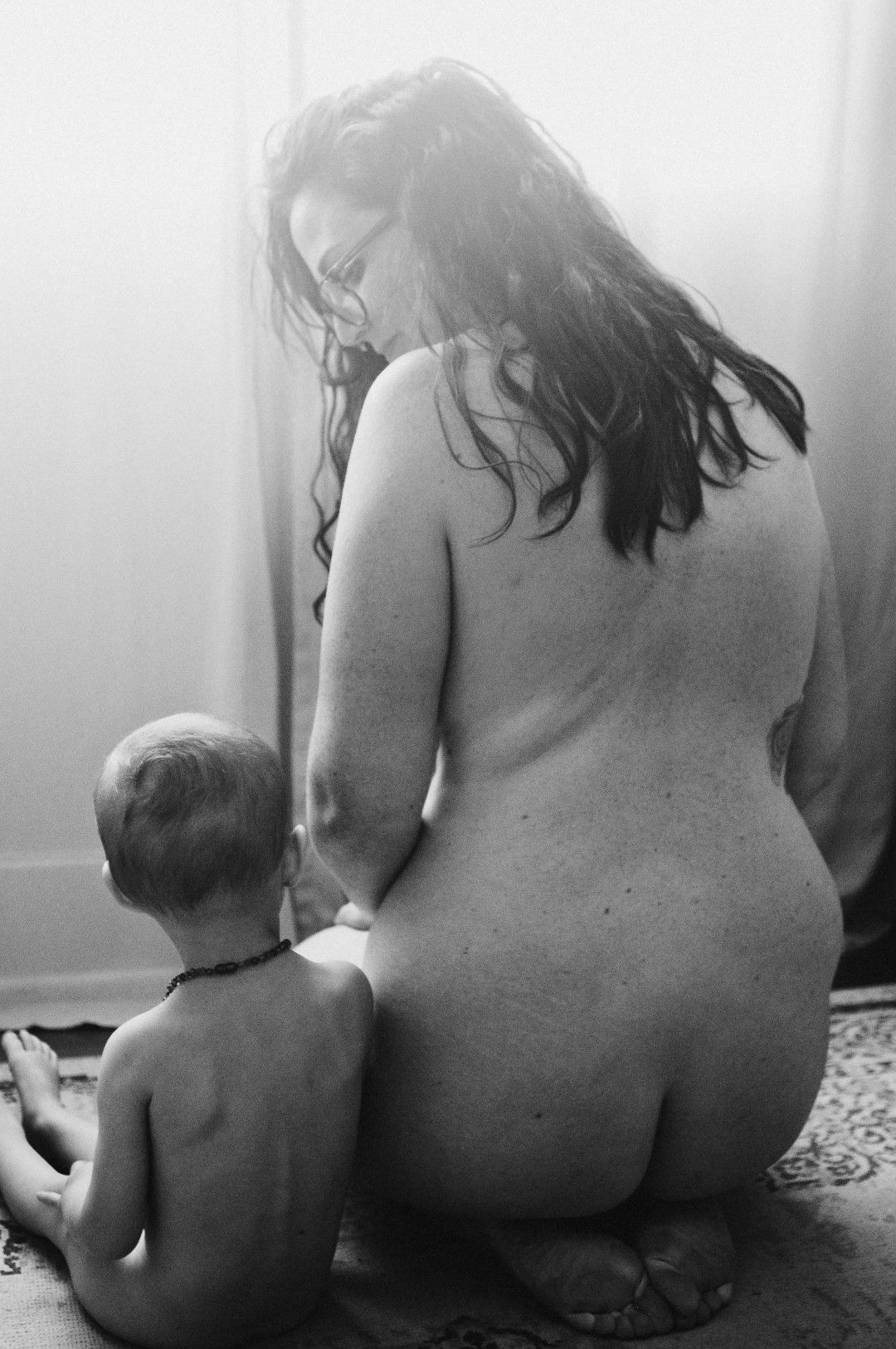 beautiful mom and daughter posing together in lifestyle breastfeeding photo