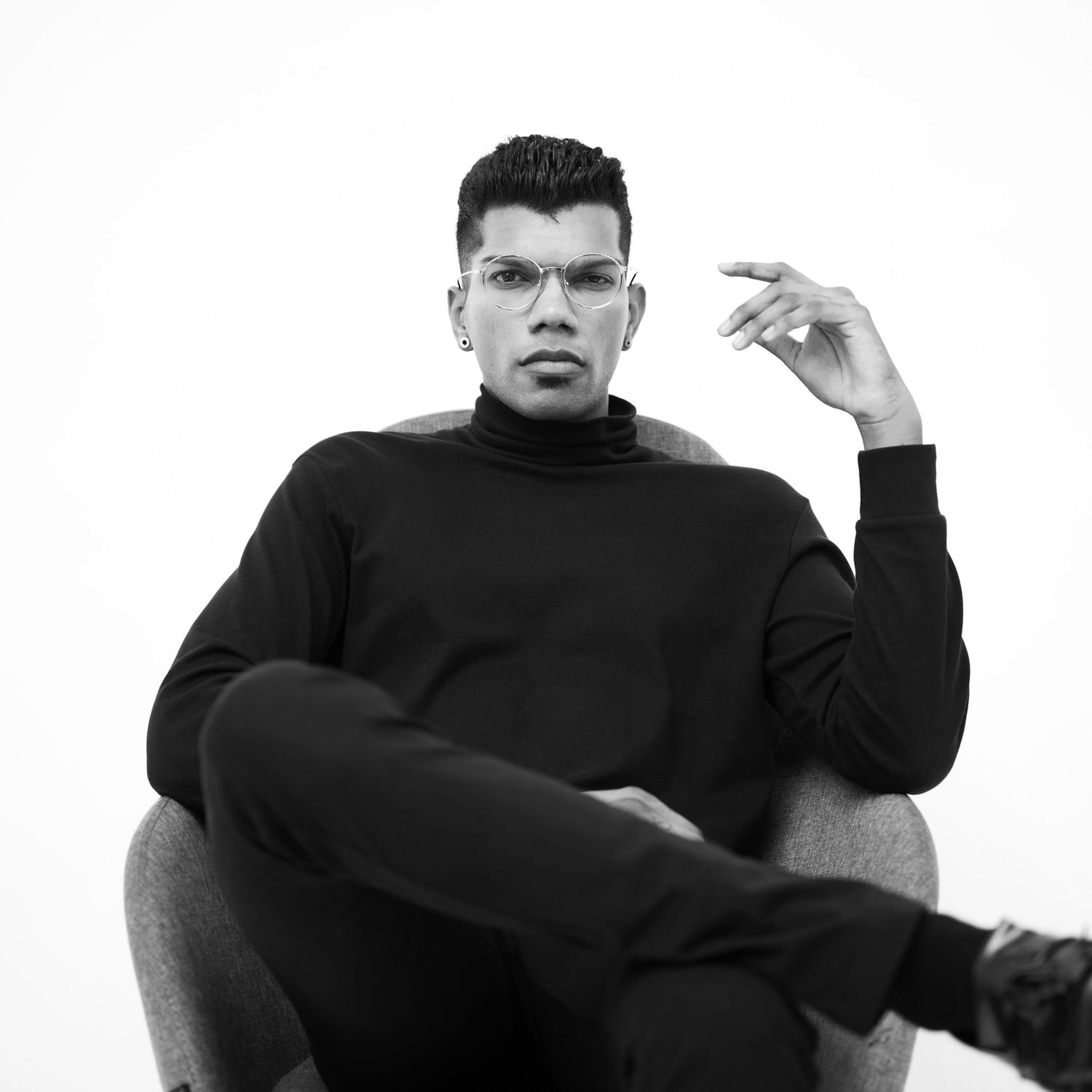 Lifestyle studio shoot while seated with cool pose