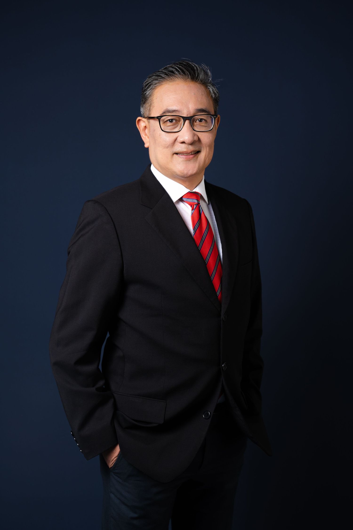 Corporate studio headshot with blue background