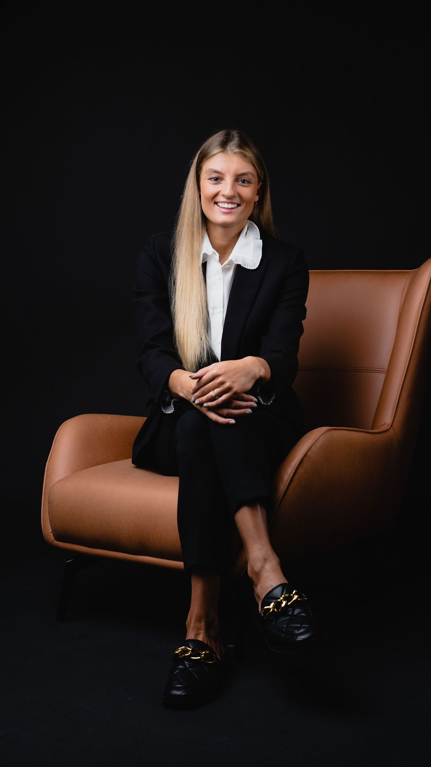 Studio Corporate portrait with lady seated while capturing it professionally