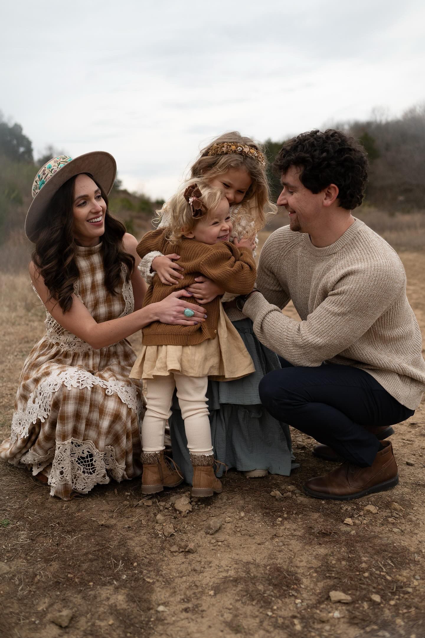 Candid family photo series showing playful moments on the ground in a rustic outdoor setting.