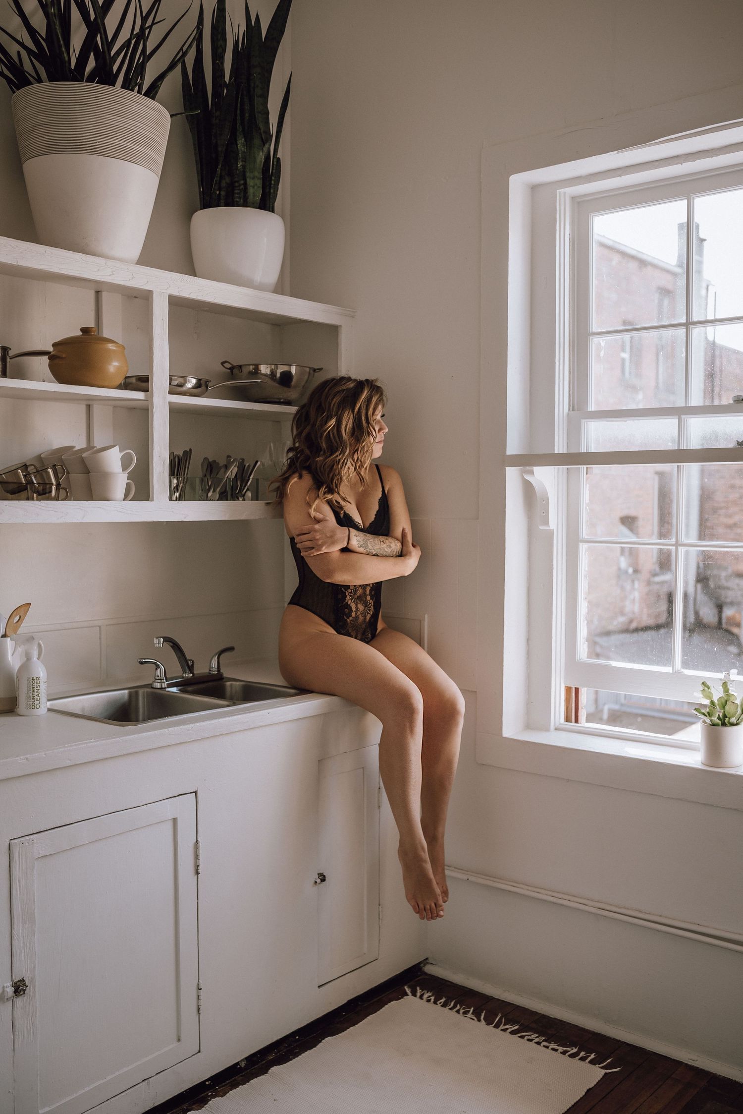 Woman posing in lingerie in kitchen