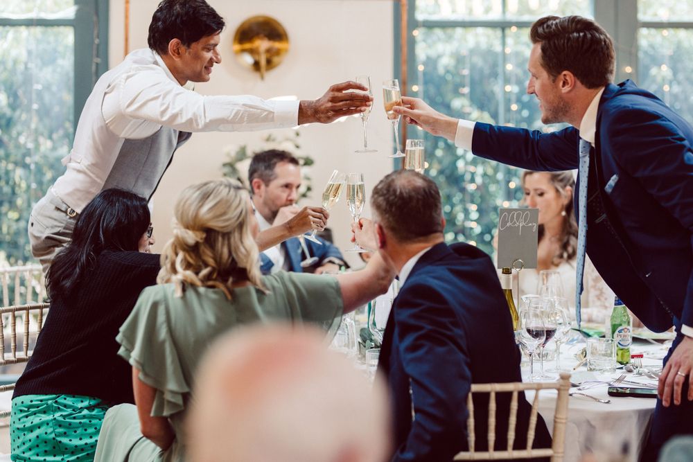 Wedding reception candid moments captured during dinner and toasts.