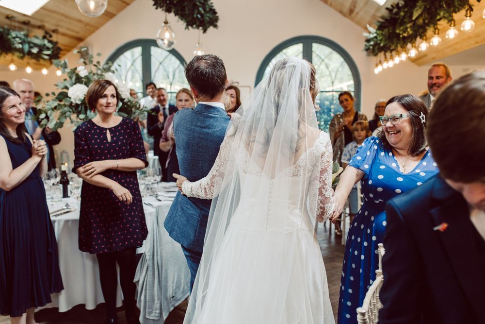 Wedding reception venue with arched windows and string lights creating warm ambiance.