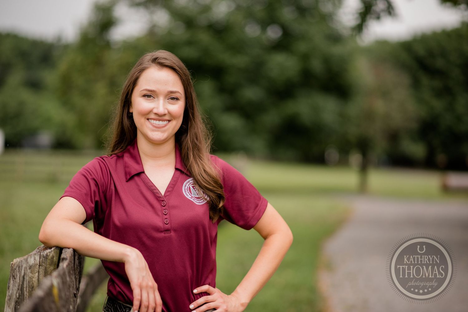 Portrait outdoors on a path with someone wearing a burgundy polo shirt.