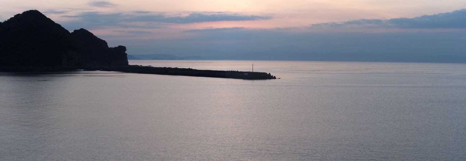 A panorama of the breakwater across the bay at sunrise
