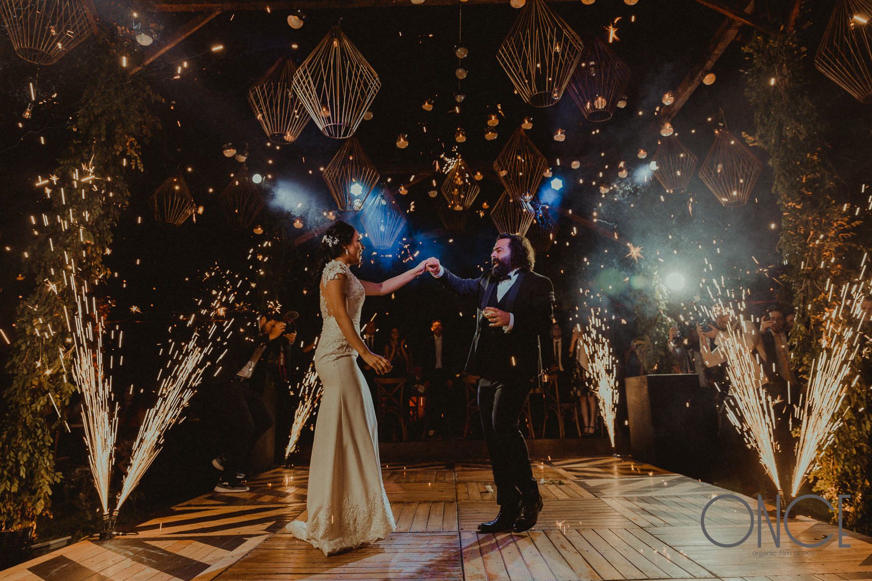 A wedding dance under sparkling lights and pyrotechnics creating a magical atmosphere.