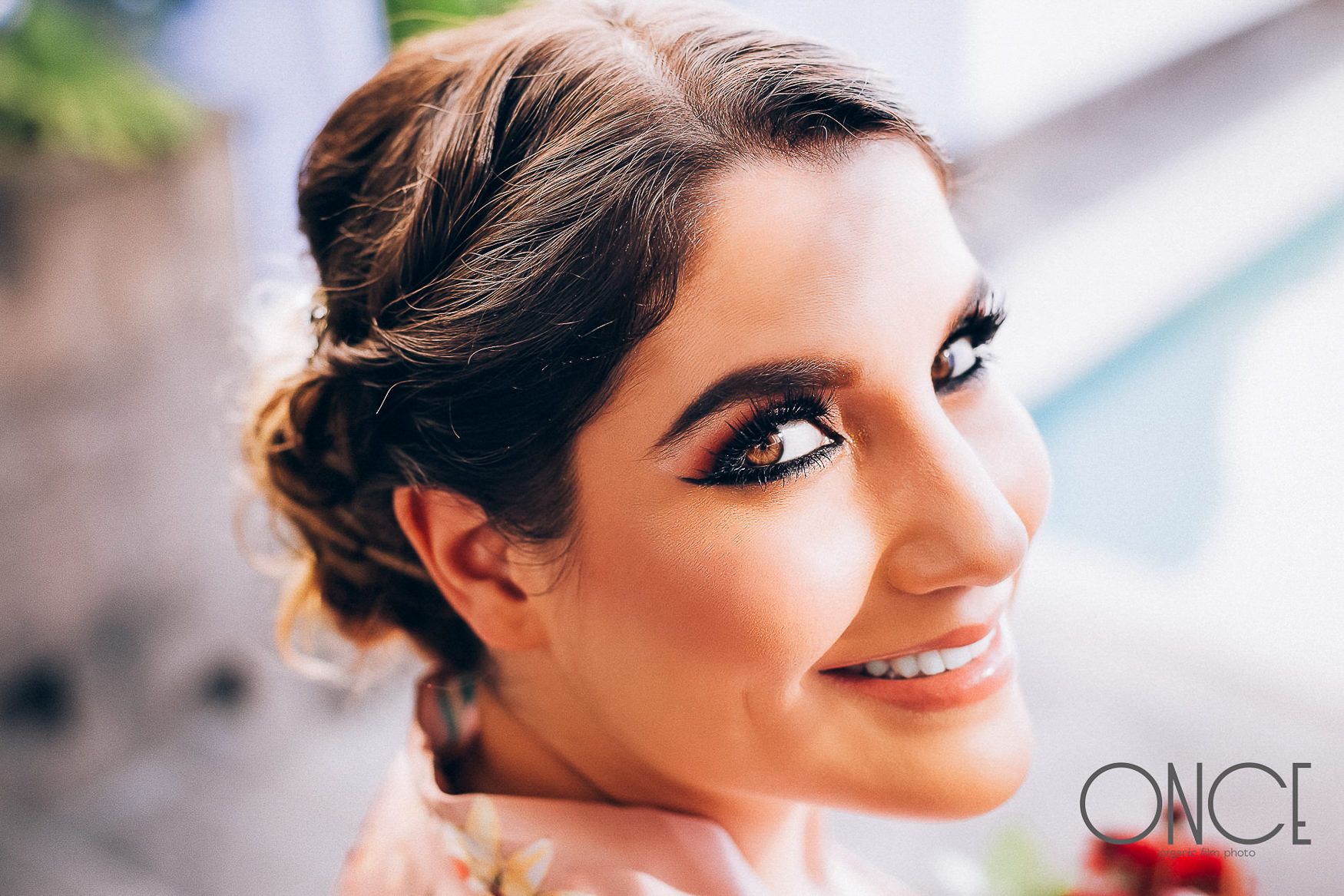 Close up portrait with soft natural lighting and elegant updo hairstyle.