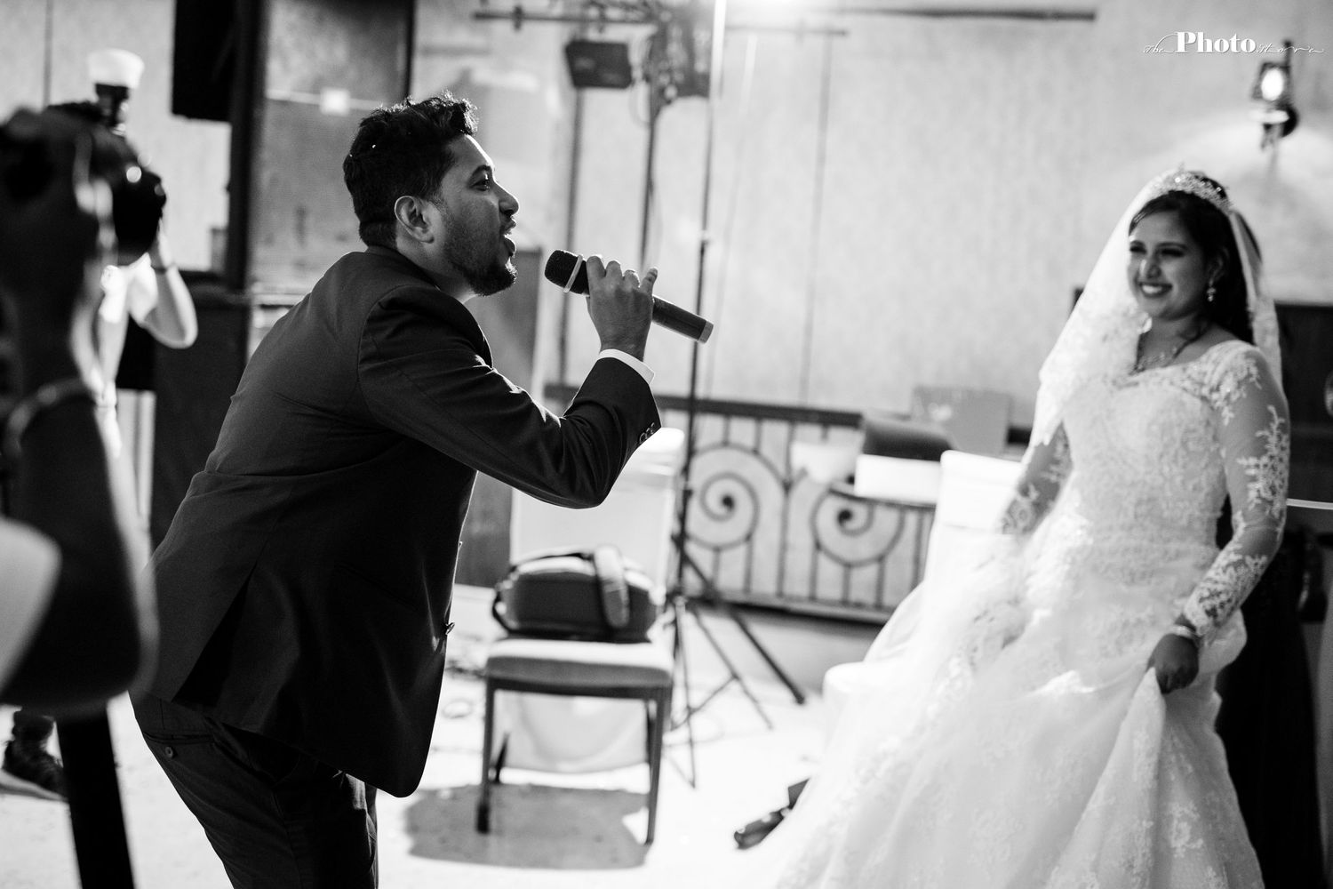 Black and white candid shot of wedding entertainment performance.