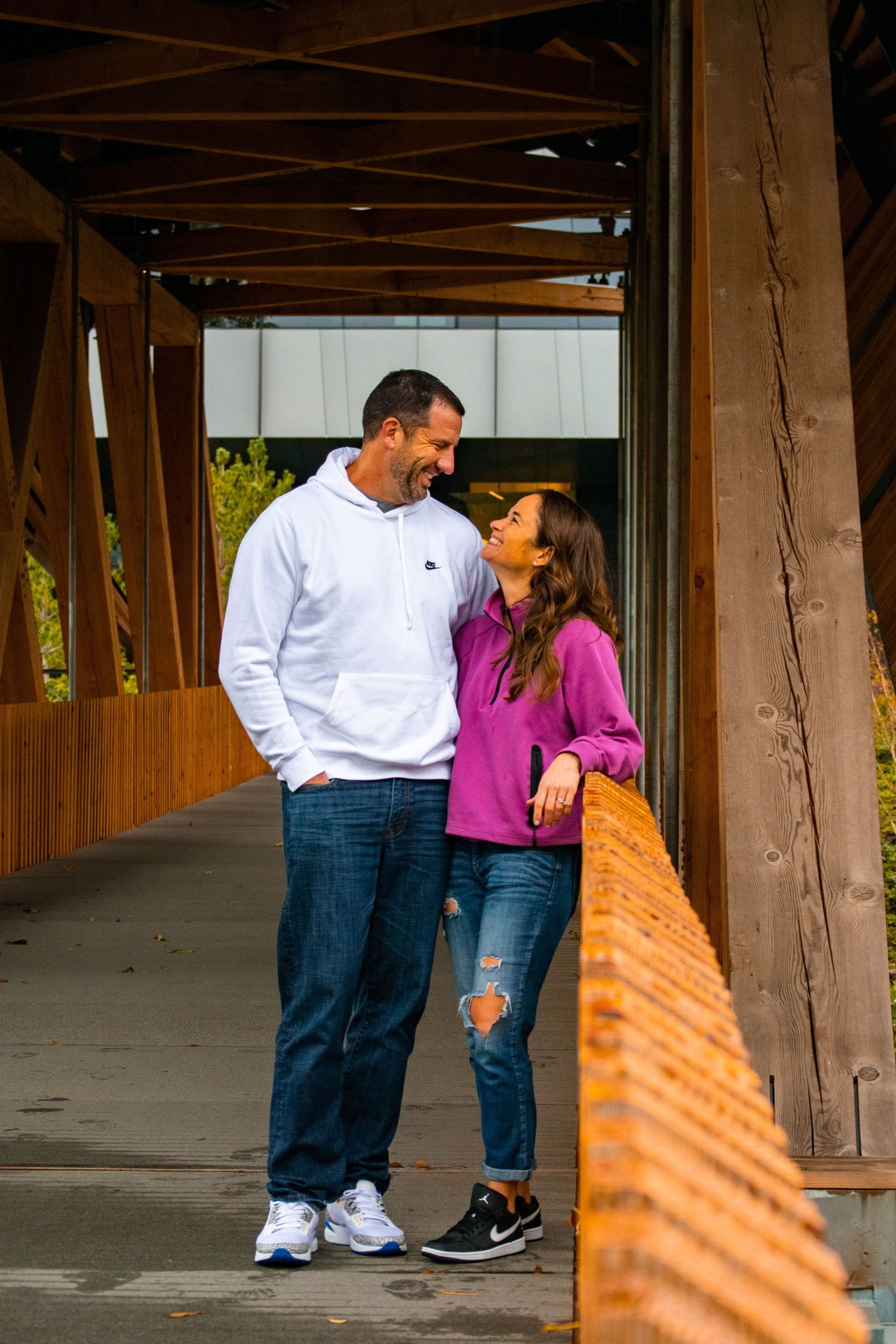 Alex Davis Photography: PNW Fall Family Photoshoot Session Parents Posing On Modern Bridge In Beaverton Oregon