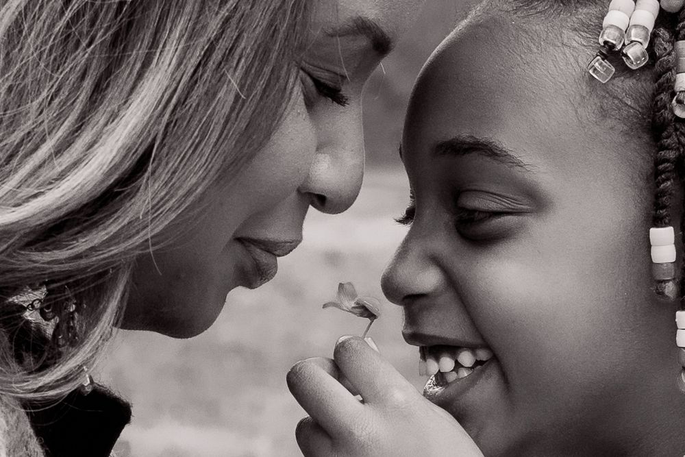 An intimate black and white close-up portrait showing joyful expressions.