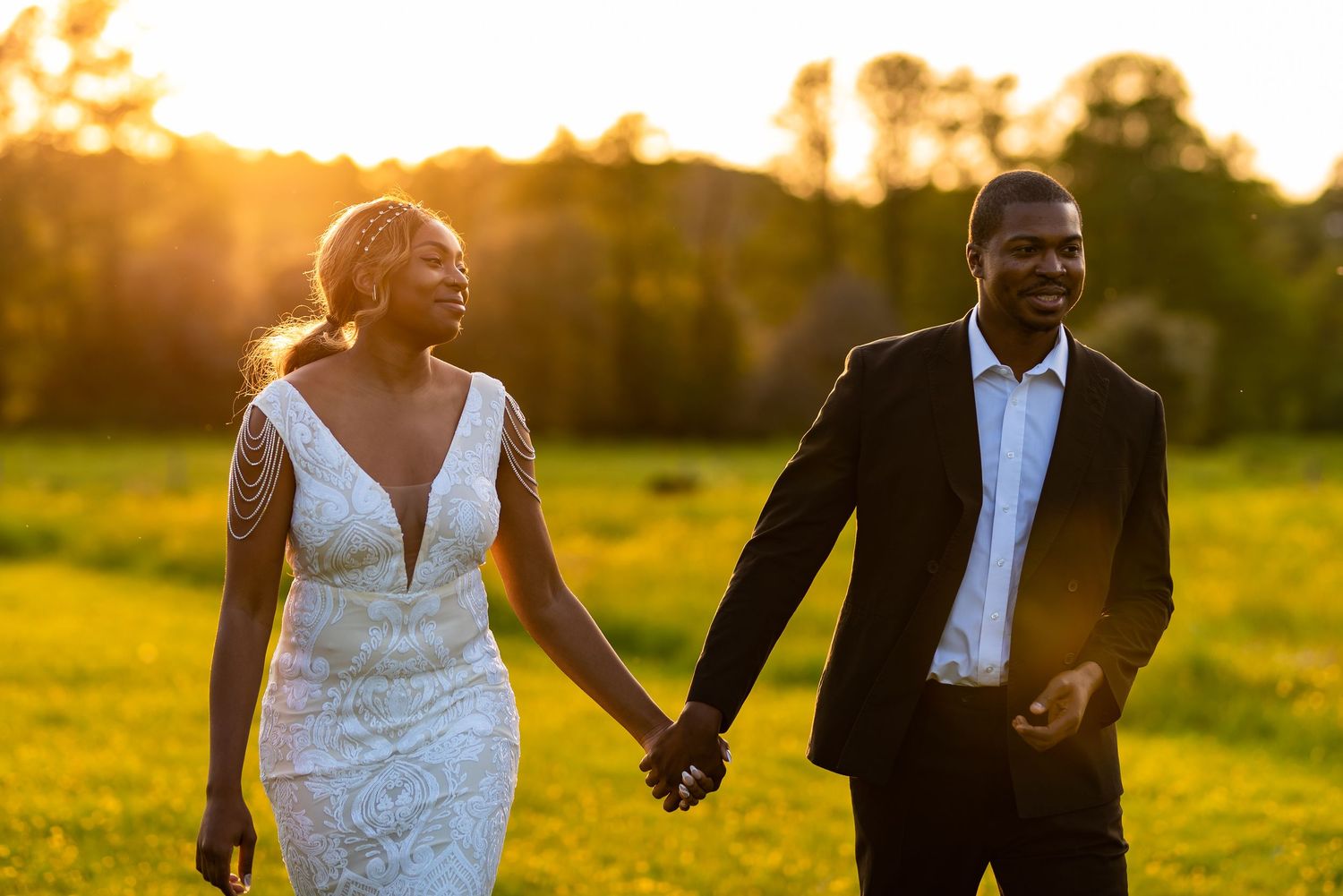 Bride and groom walking in the sunset. Farnham, Surrey