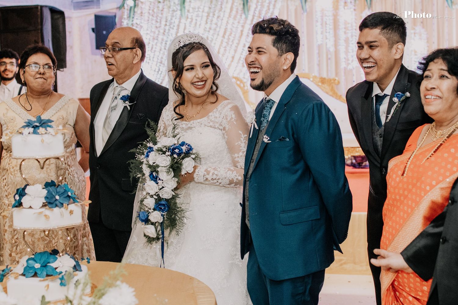 Wedding reception scene with elegant floral decorations and guests celebrating.
