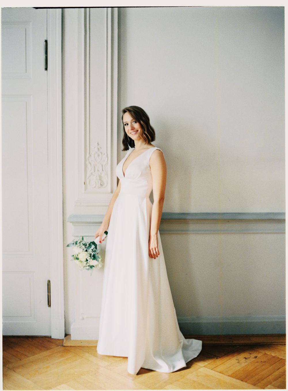 A flowing white dress captured in minimalist interior shots against pale grey walls.