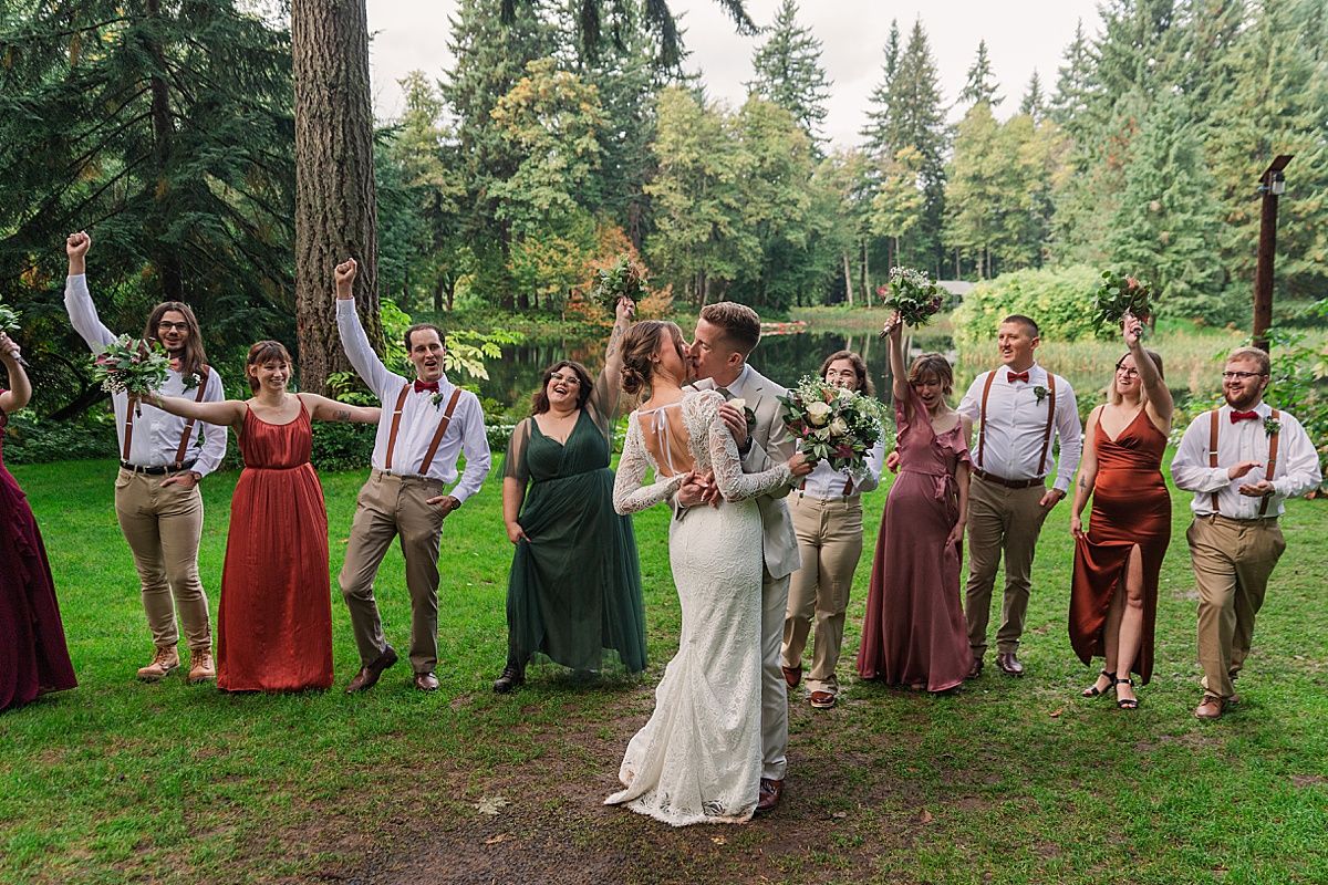 Bride and Groom kiss while wedding party cheers at Bridal Veil Lakes Oregon wedding