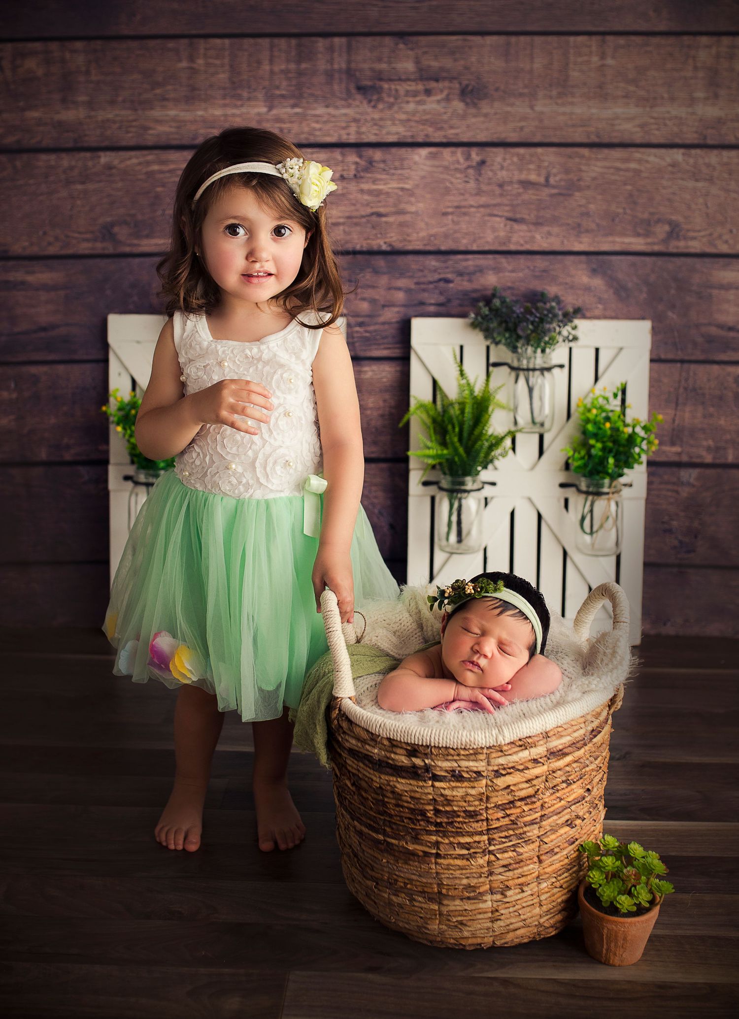 big sister and newborn baby pose for detres photography