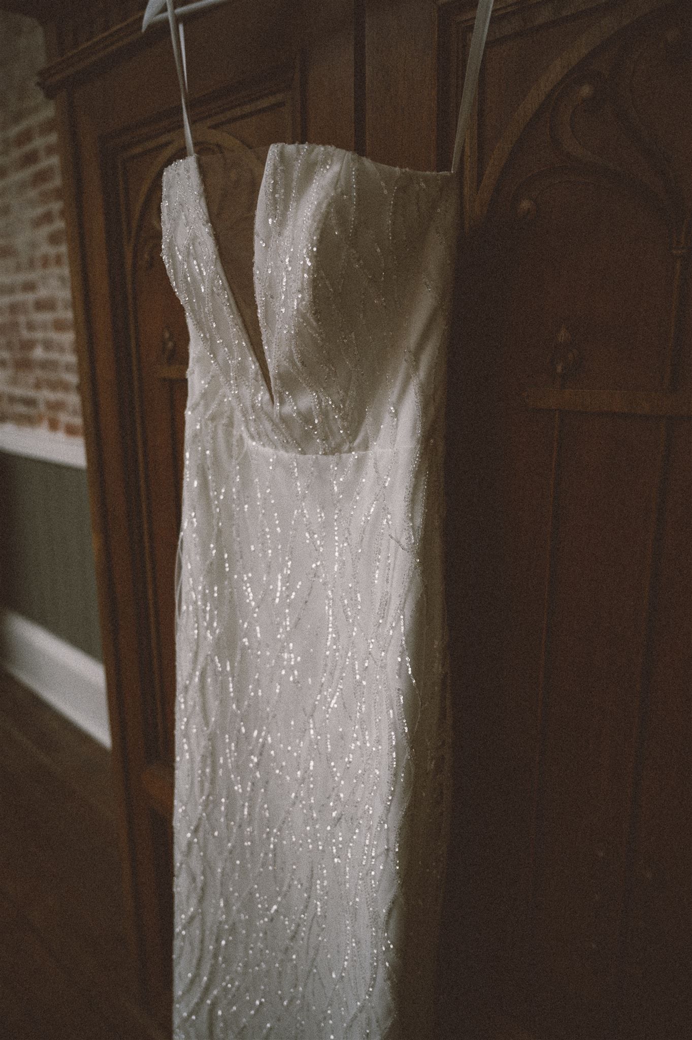 Close-up of sparkly white wedding dress details and fabric texture.