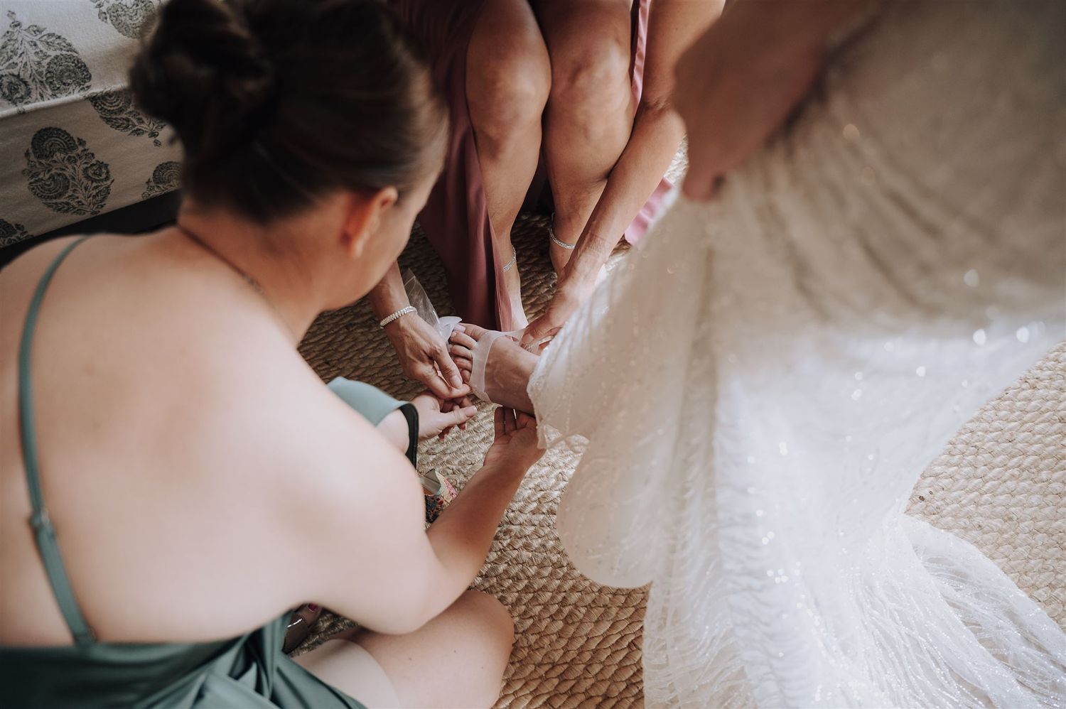 Close-up shot of dress alterations being made to a white wedding gown.