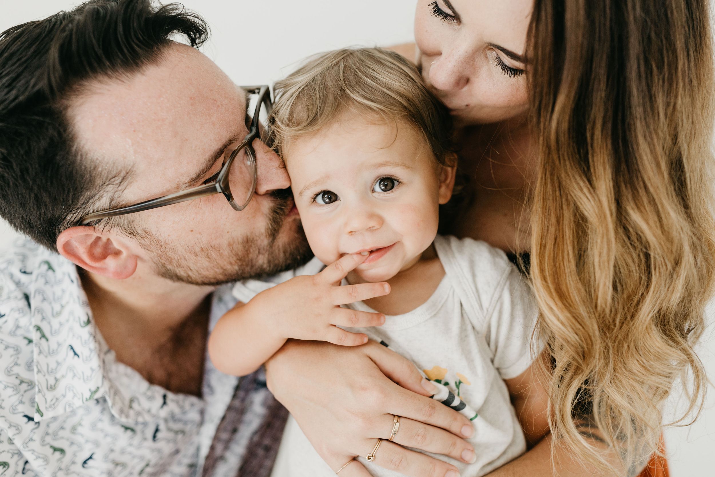 Intimate family portrait showing tender moments and embraces.