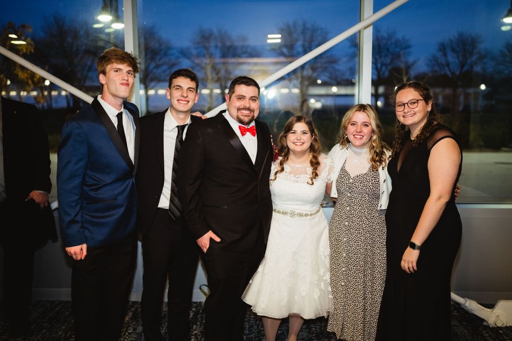 Group in formal attire posing at evening event.