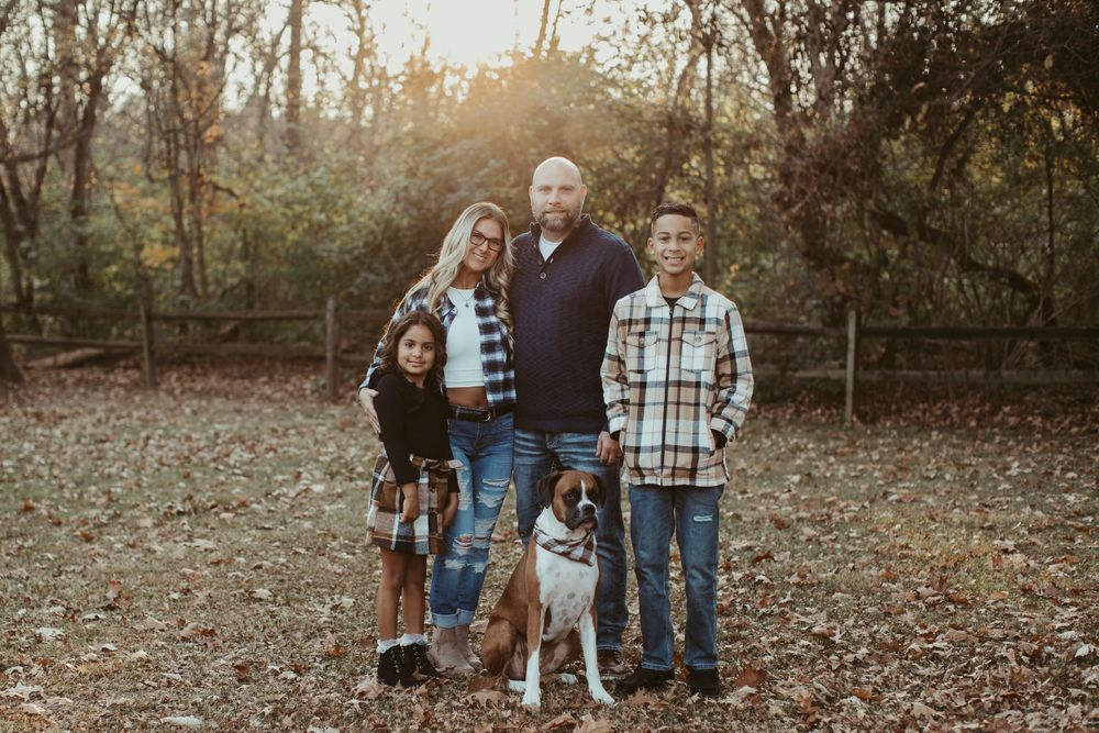 Casual family gathering in a wooded area during autumn.