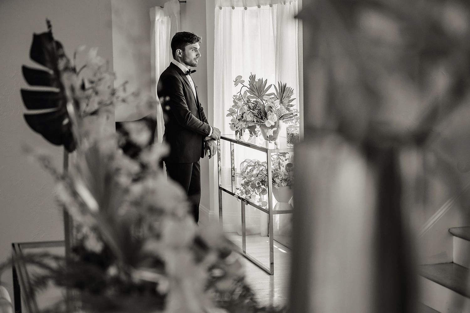 Black and white getting ready wedding photos through window reflection.