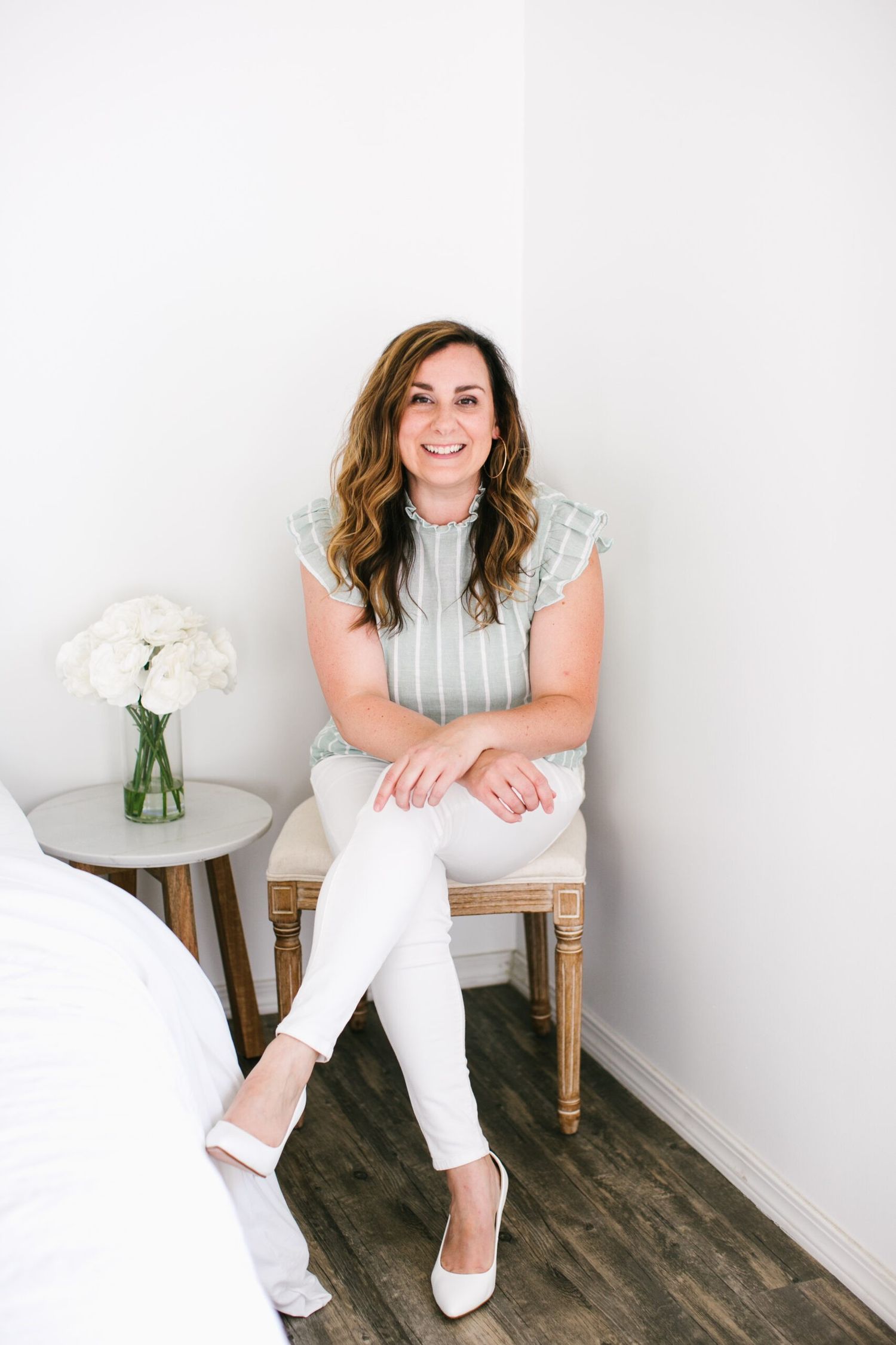 Lifestyle portrait of photographer Olivia Gird smiling during a relaxed Rhode Island branding session.