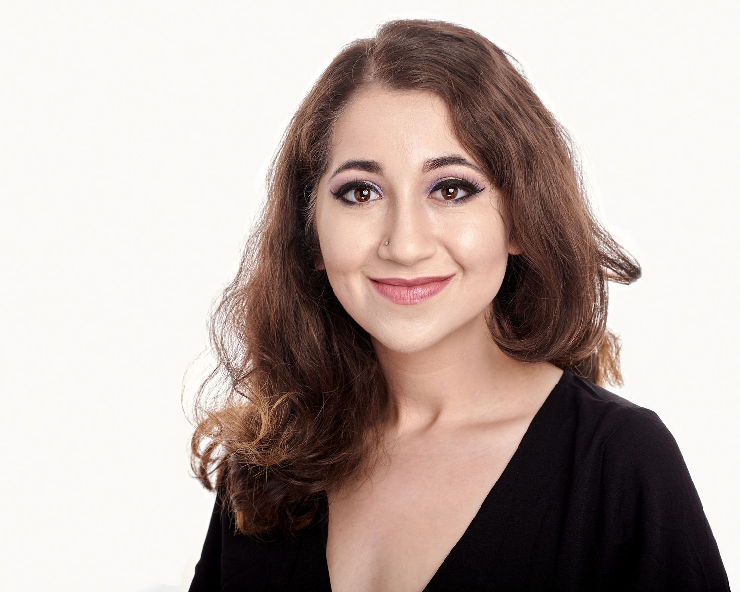headshot of a beautiful young woman with dark hair and white background