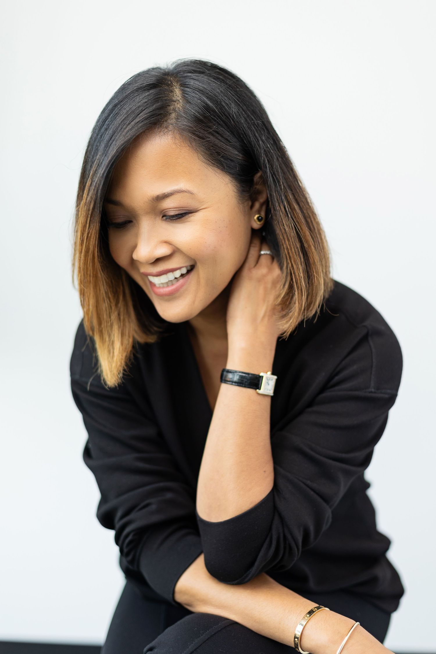 Studio portrait series showing relaxed poses in black attire against white backdrop.