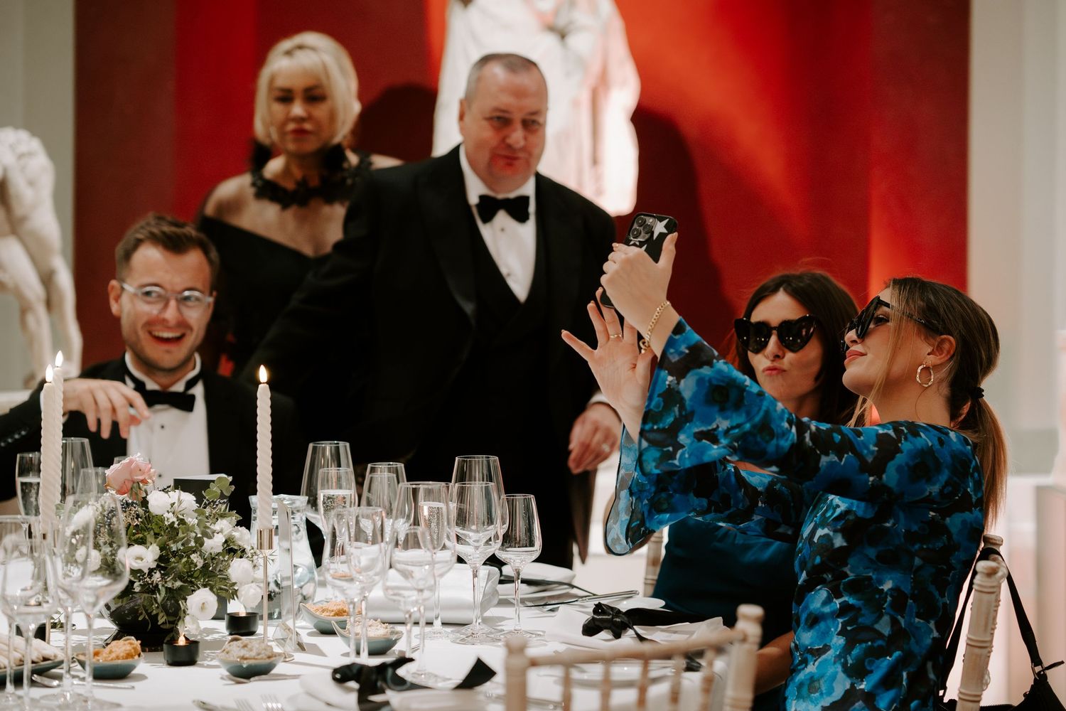 wedding guests sat around tables in the grand sculpture gallery at the Ashmolean Museum in Oxford