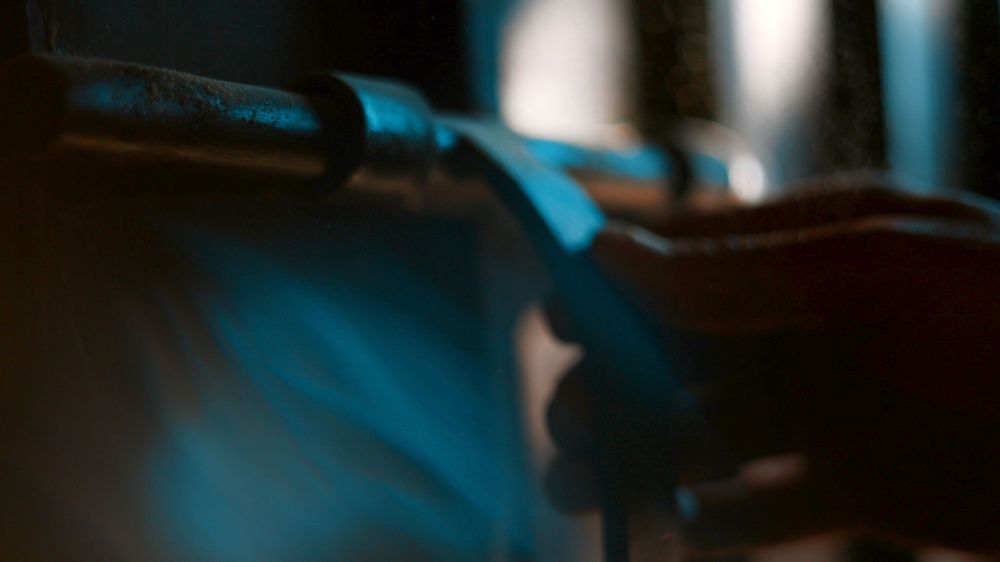 Abstract blurred composition in cool blue tones with dark shadows.