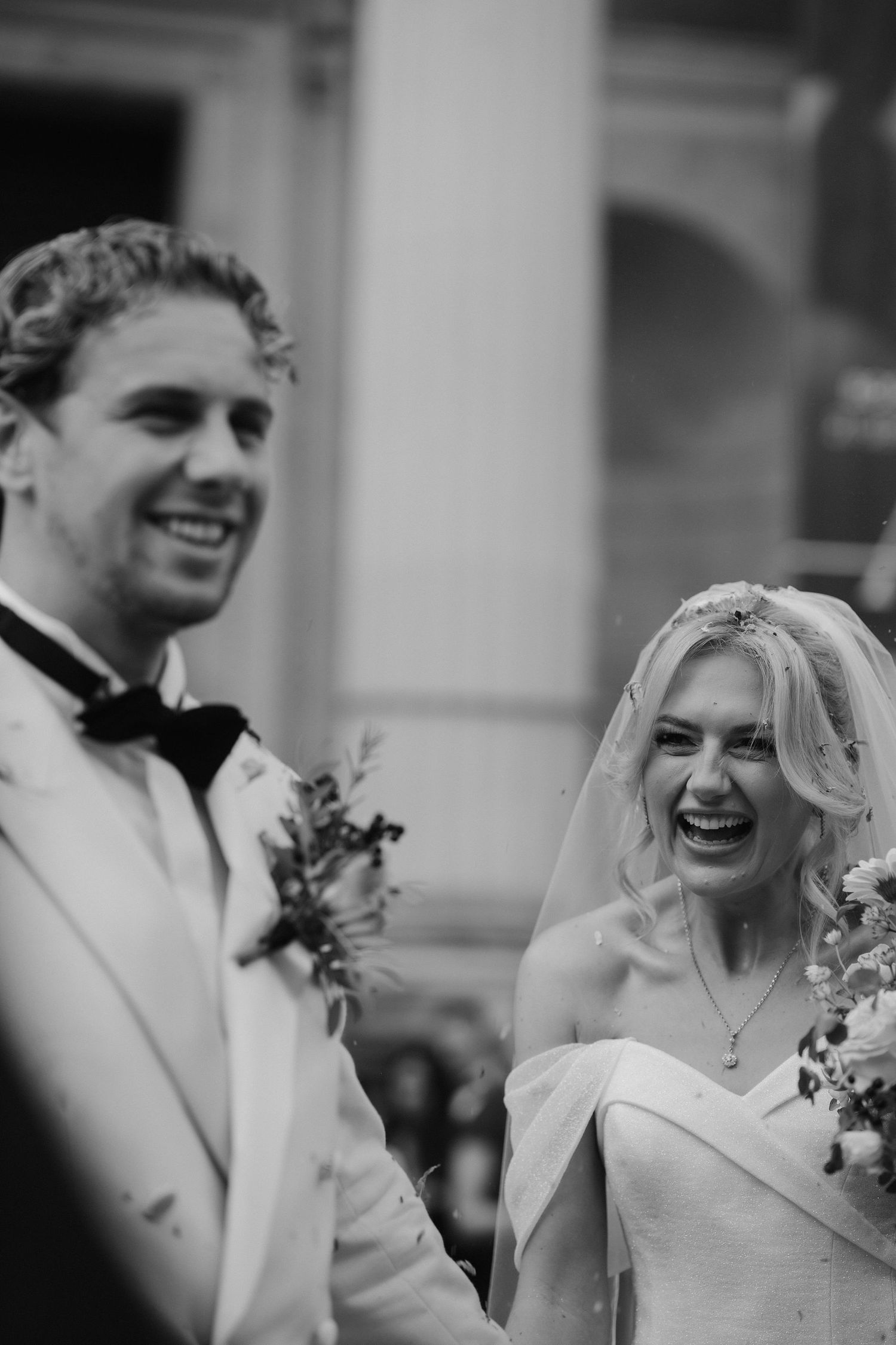 confetti being thrown over bride and groom as they leave the Ashmolean Museum
