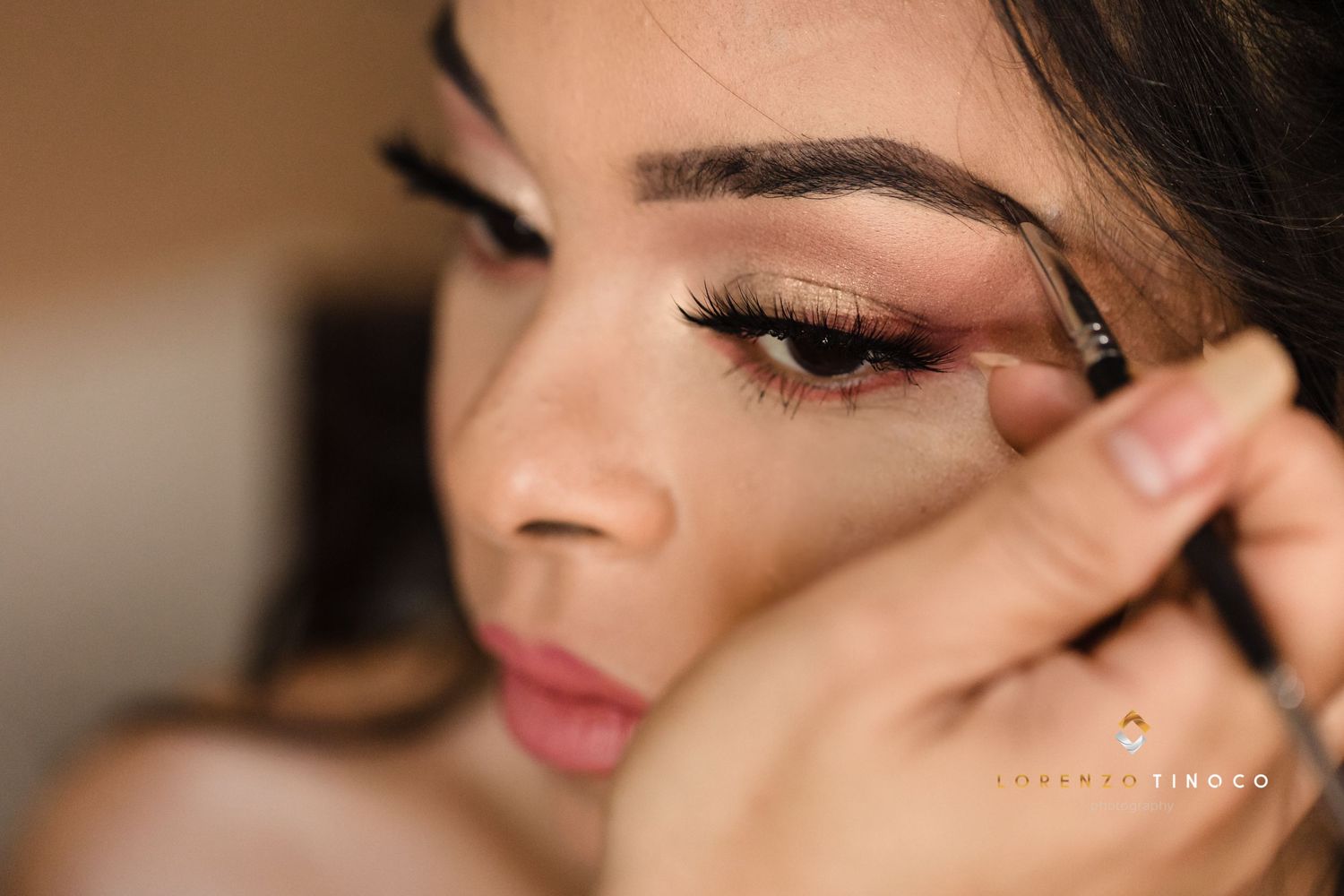 Professional makeup application focusing on precise eyebrow grooming technique.