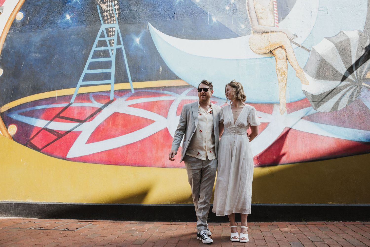 just married couple looking cool in Brighton against graffiti