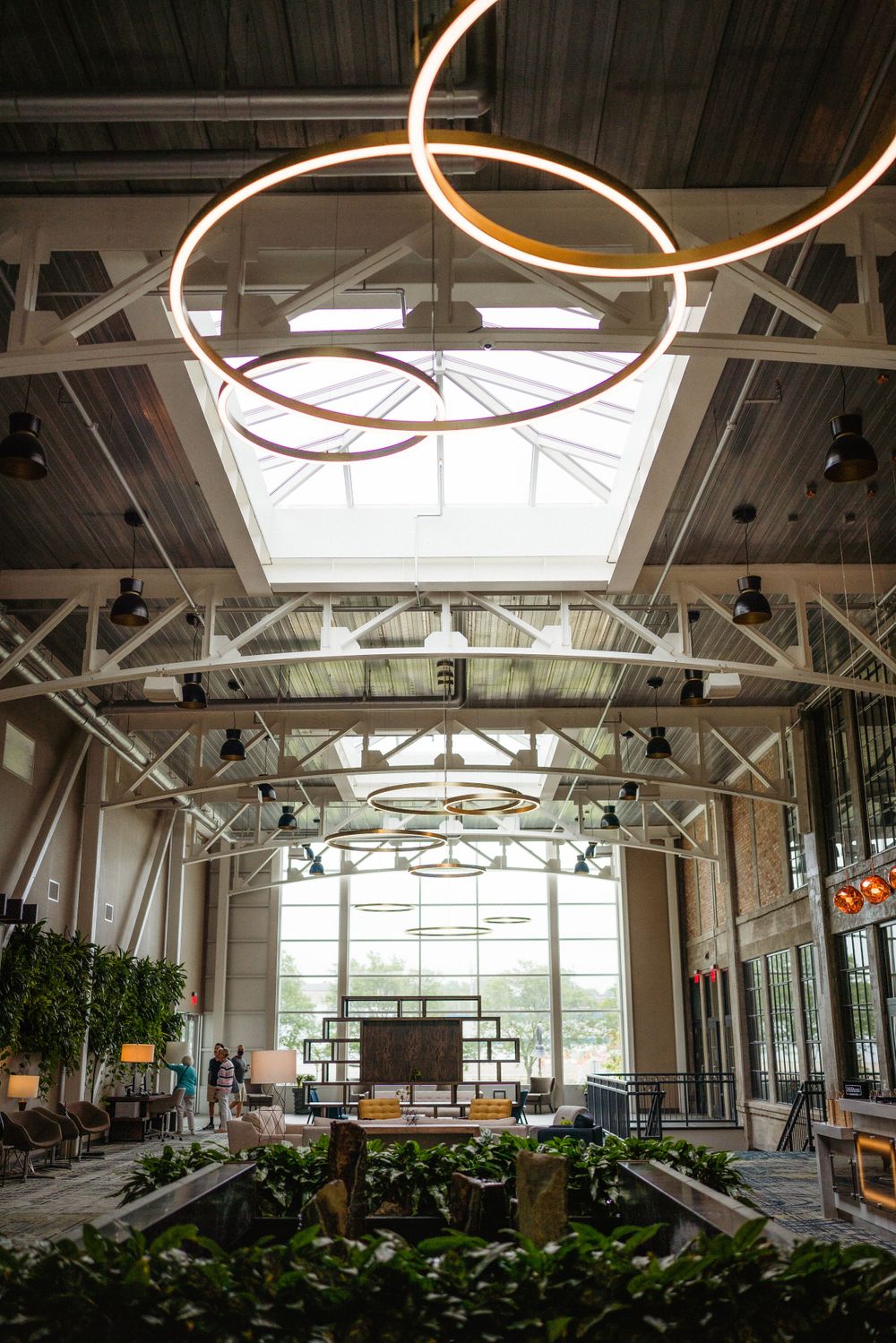 Modern venue interior with circular hanging lights and industrial ceiling design.