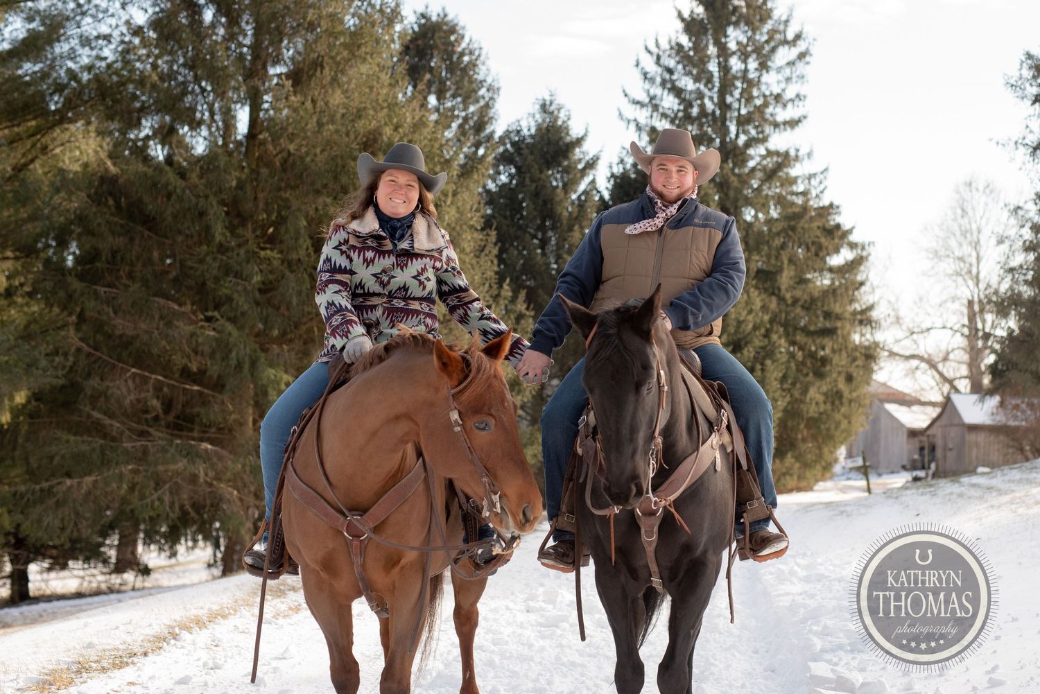 Two riders on horseback enjoy a winter trail ride through snowy evergreen forest.
