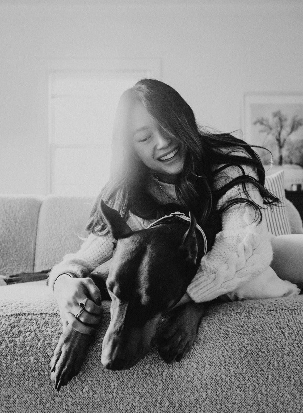 pet portrait smiling woman with dog on the couch