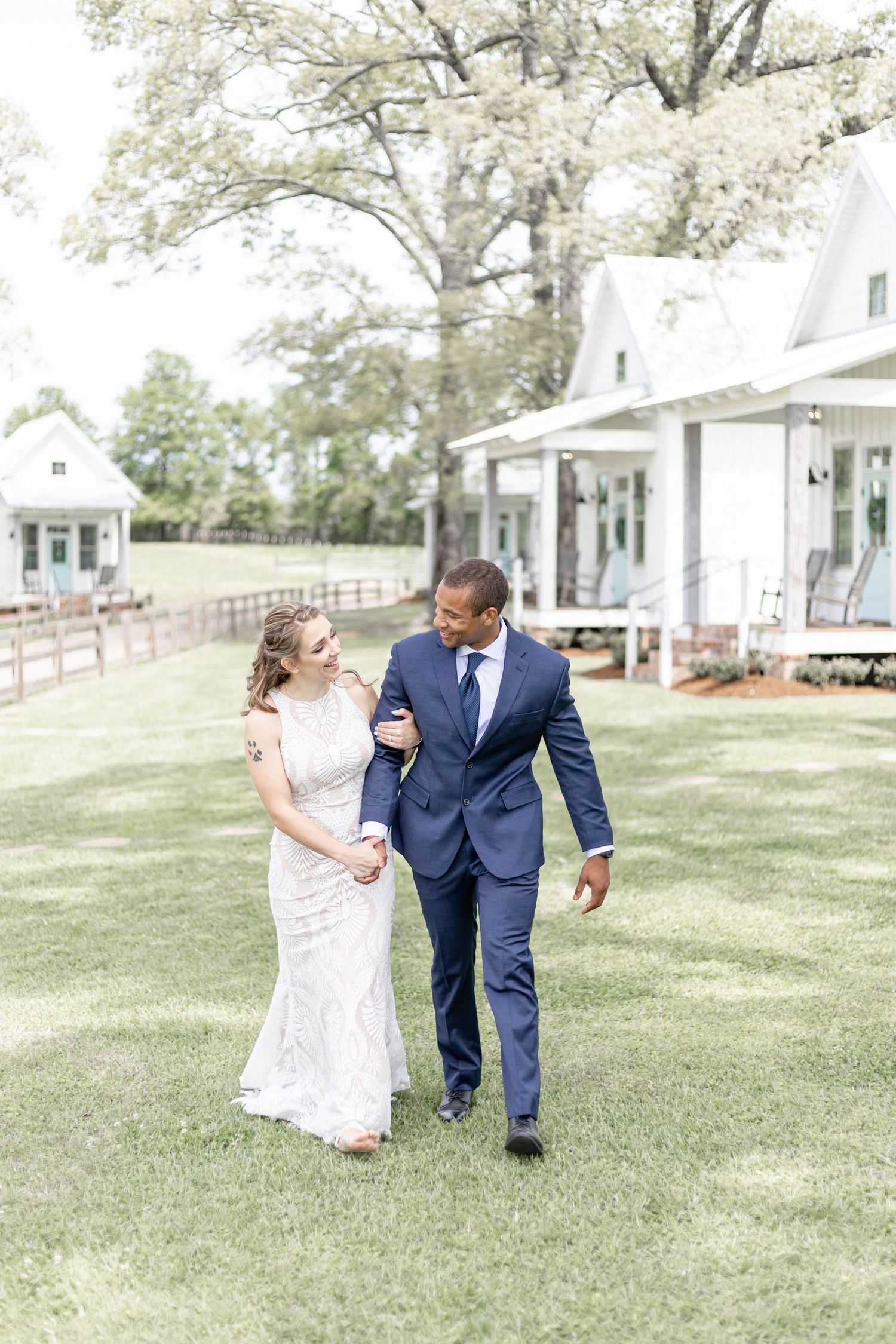 bride and groom walk at the white magnolia in Kentwood, LA