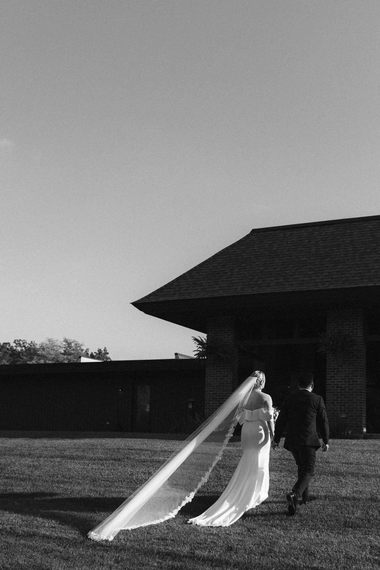 Dramatic black and white photo series of a bride's dress flowing in the wind.