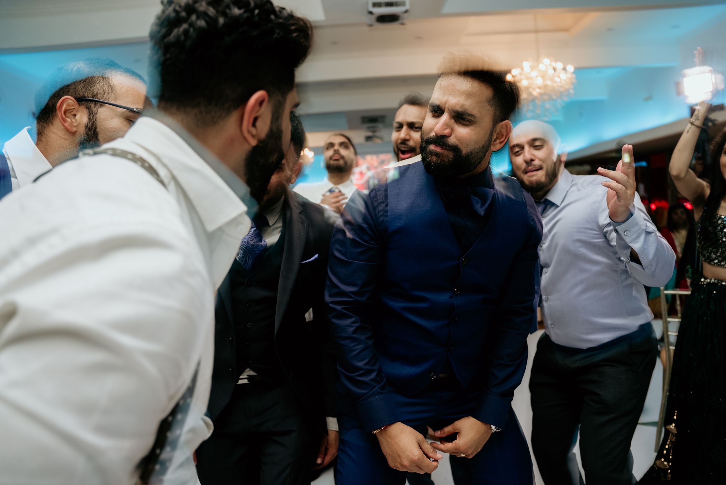 Wedding guests enjoying and sharing laughs during a festive celebration.